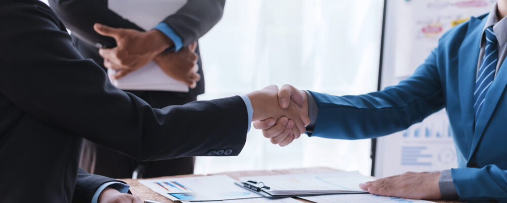 Business success. Business people handshake agreement confirmed in the investment business. Successful business people meeting together. Business success. Business people handshake agreement confirmed in the investment business. Successful business people meeting together.