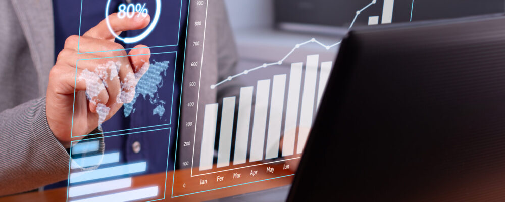 Successful Business Trends: Businessman Analyzing Rising Graphs in Modern Office Successful Business Trends: Businessman Analyzing Rising Graphs in Modern Office