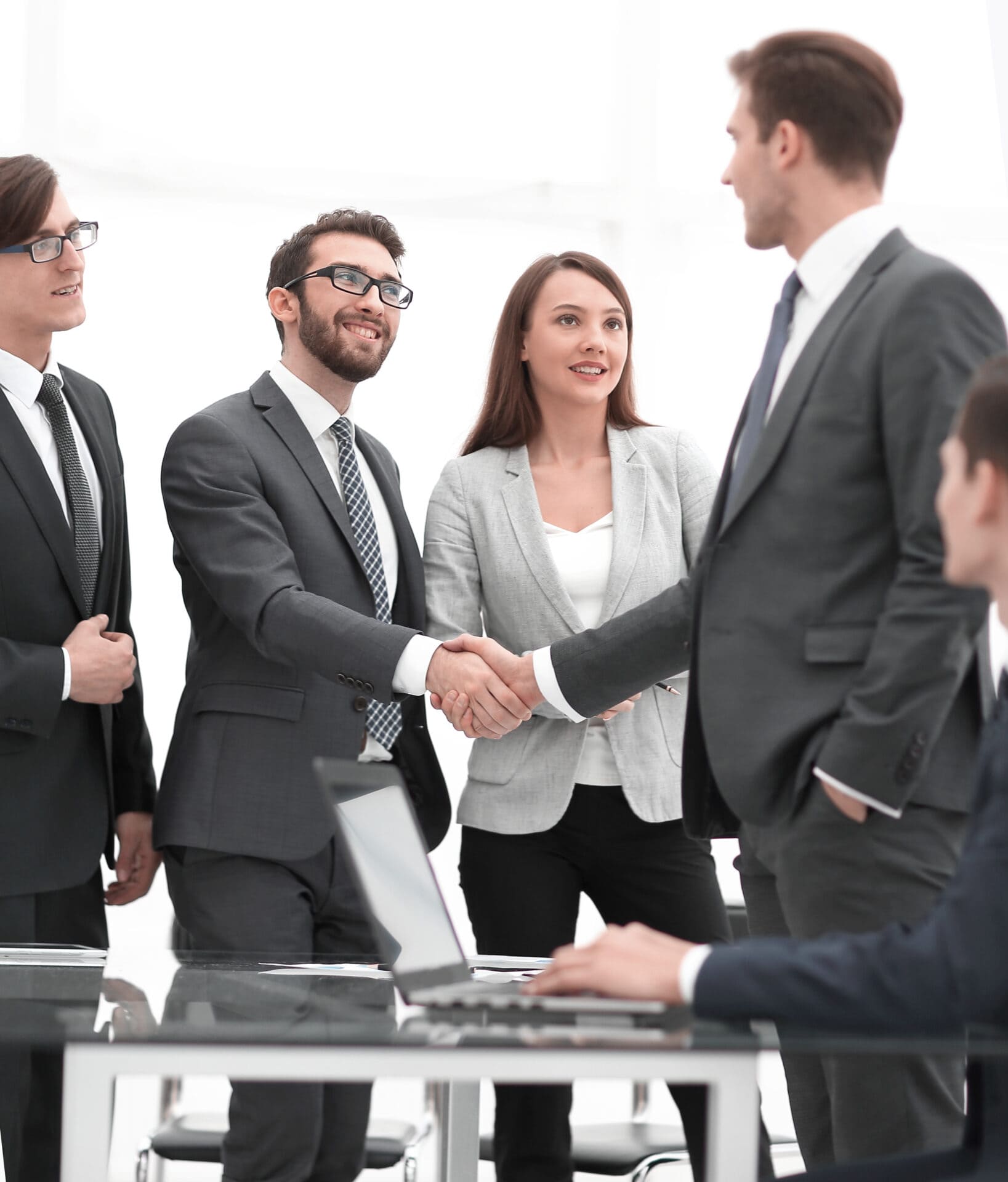 Business colleagues sitting at a table during a meeting with two- Many business people